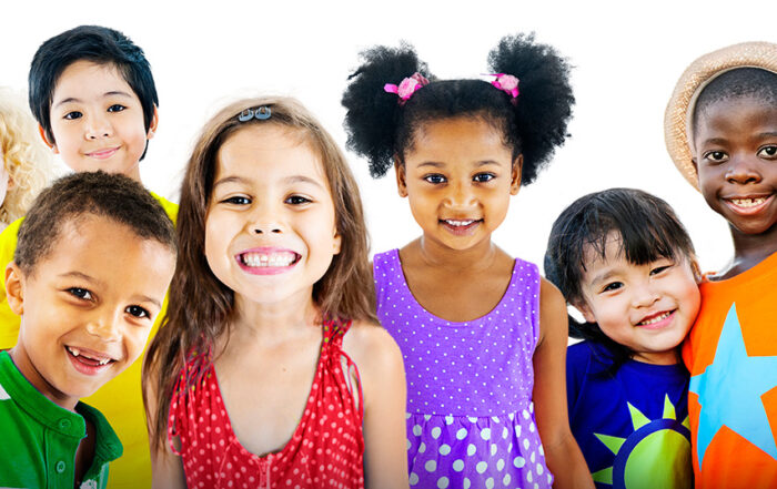 A group of foster care children posing in front of a white background.