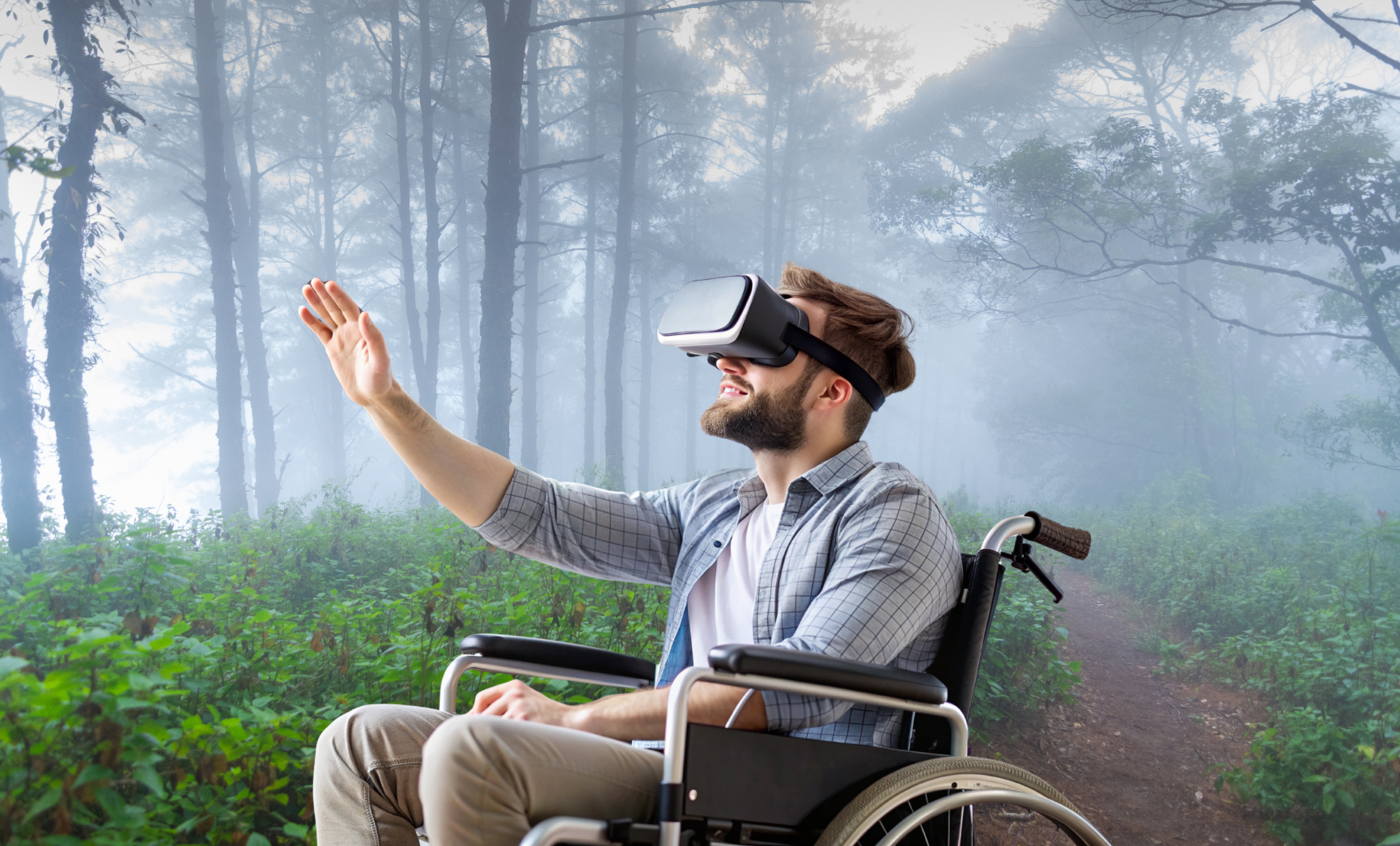 A man in a wheelchair wearing virtual reality goggles reaches out, exploring a misty forest path—an inspiring moment made Virtually Possible by SKSF.